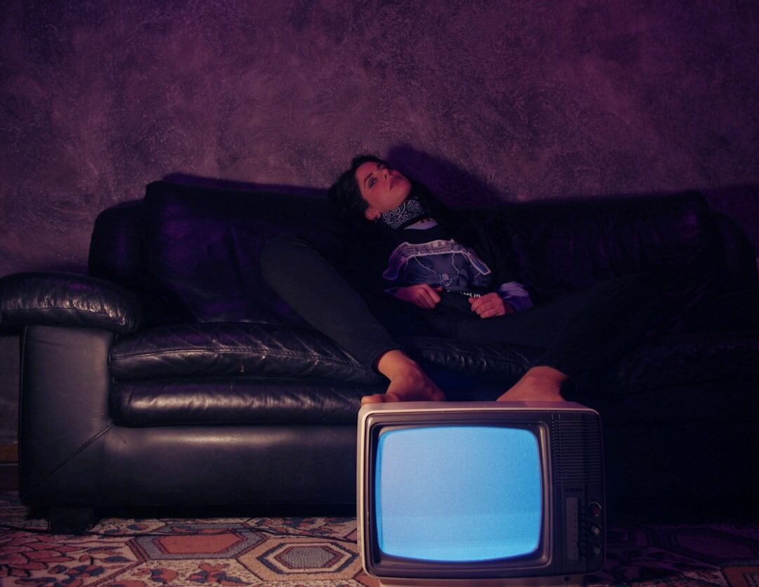 person on couch watching tv