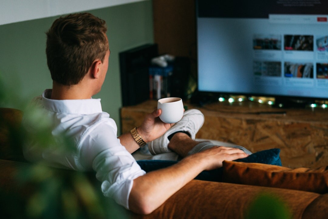 person watching tv series at night