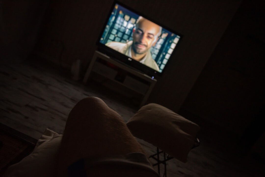 person watching tv series at night